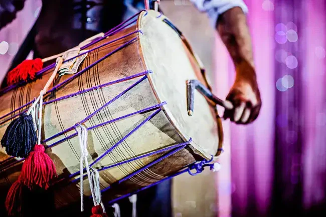 Professional live dhol player performing at Indian wedding baraat entrance ceremony